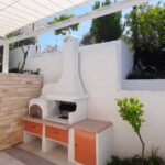 Luxury outdoor living at Minthis Hills: Palazzetti Malibu BBQ & Oven with granite worktop and storage module by Bio Energy